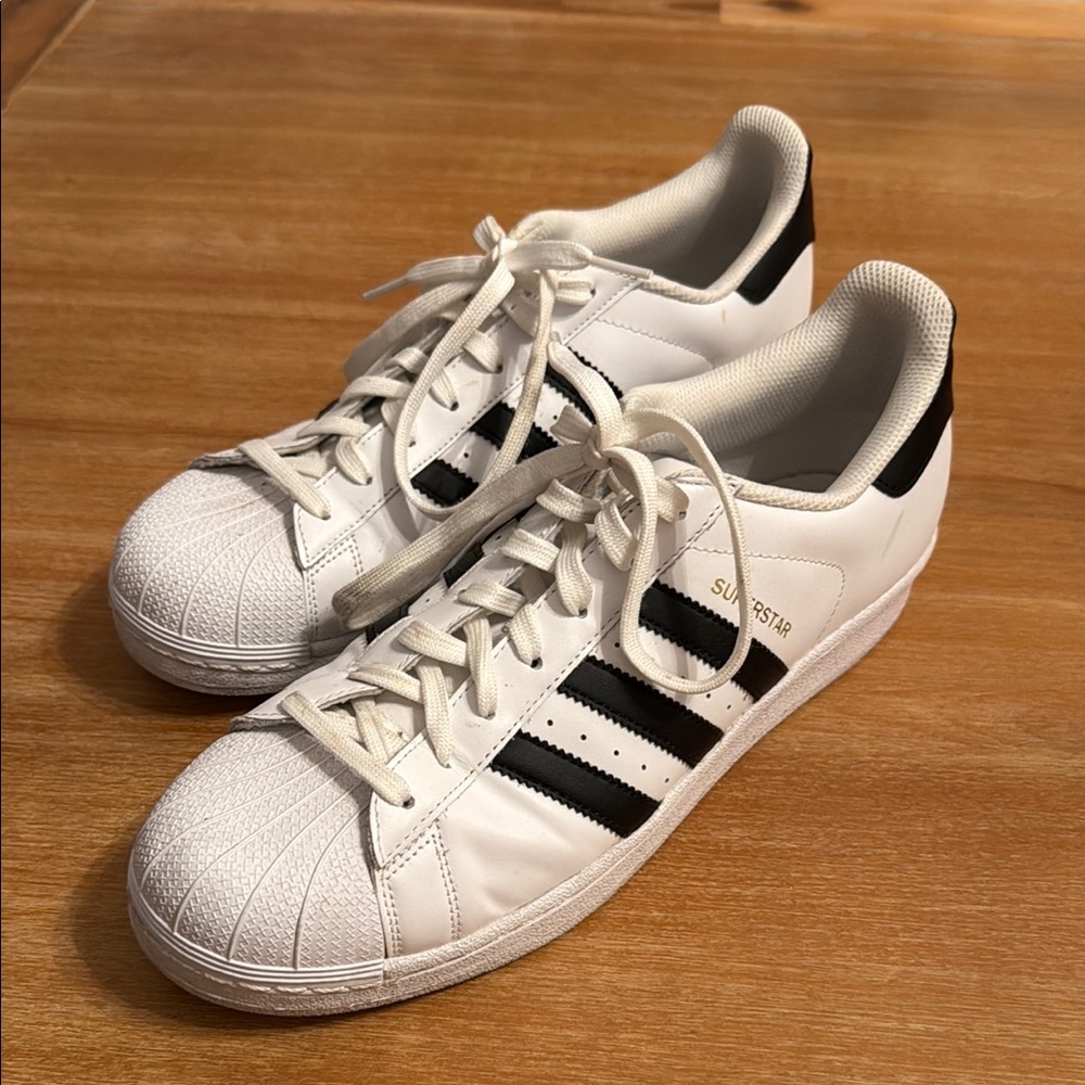 Adidas White Sneakers with Black Stripes and Gold Accents